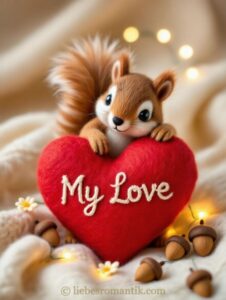 Flauschiges Eichhörnchen sitzt auf rotem Herz mit „My Love“, umgeben von Eicheln und Blumen.